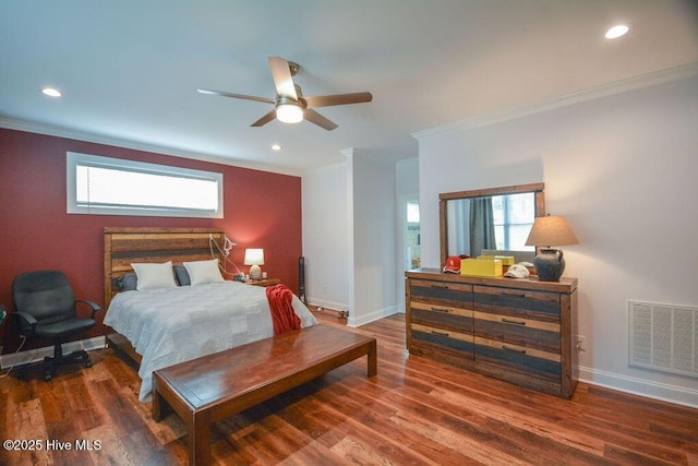 bedroom featuring visible vents, ornamental molding, baseboards, and wood finished floors