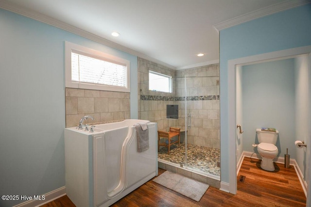 bathroom with toilet, ornamental molding, wood finished floors, baseboards, and walk in shower