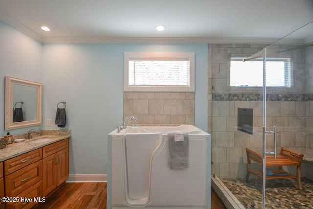 bathroom with a shower stall, crown molding, wood finished floors, and a healthy amount of sunlight