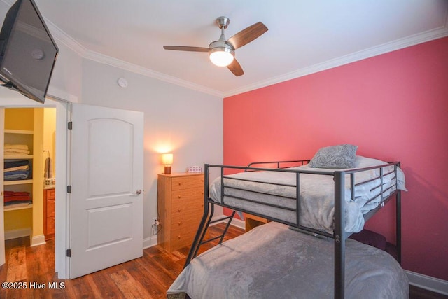 bedroom featuring ceiling fan, crown molding, baseboards, and wood finished floors