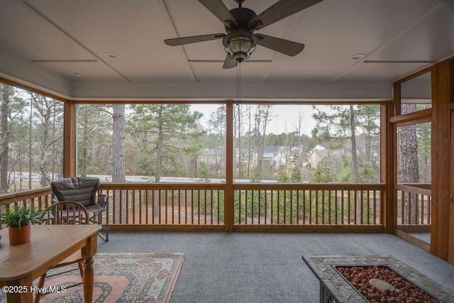 sunroom / solarium with a ceiling fan