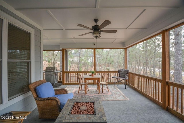 sunroom / solarium with a ceiling fan