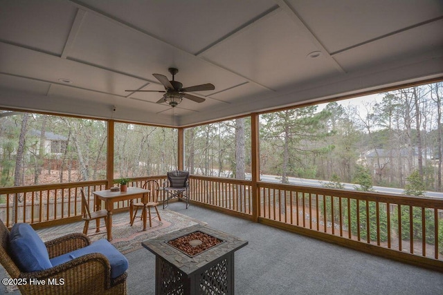 sunroom / solarium featuring a ceiling fan