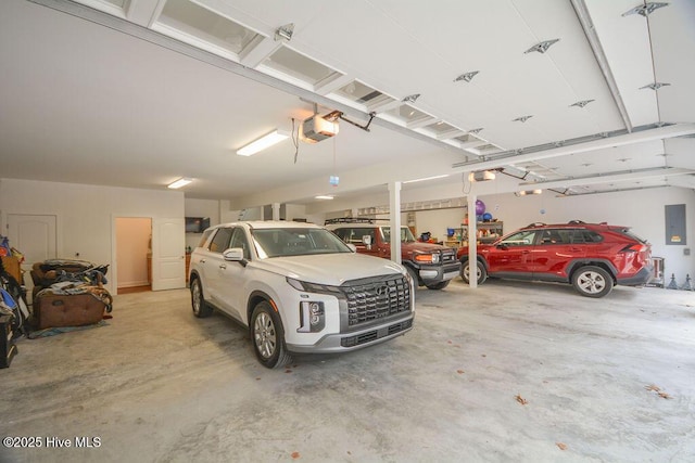 garage with electric panel and a garage door opener