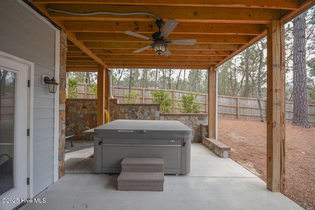 view of patio with fence and a hot tub