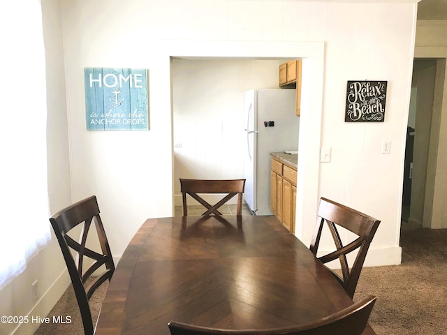 dining space featuring carpet flooring