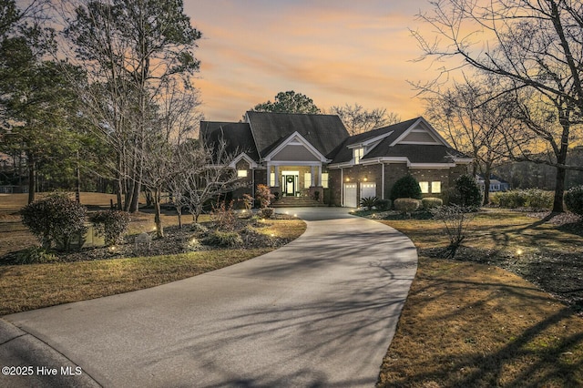 craftsman inspired home featuring concrete driveway and an attached garage