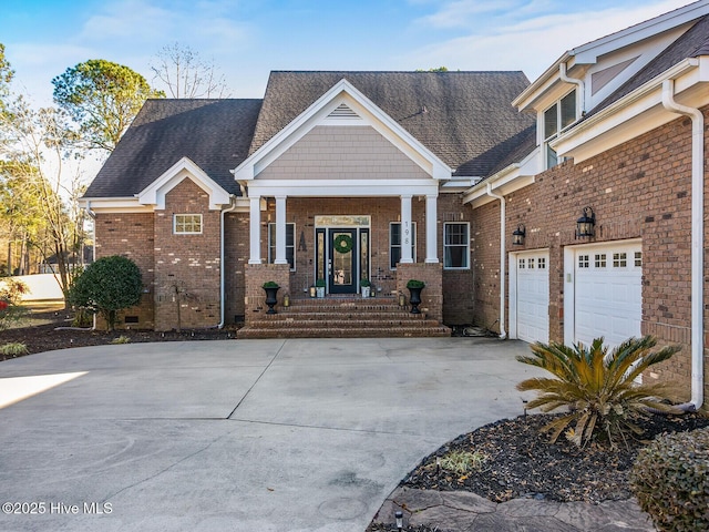 craftsman house featuring a garage, brick siding, driveway, and a shingled roof