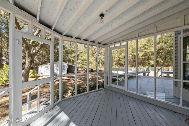 unfurnished sunroom featuring lofted ceiling