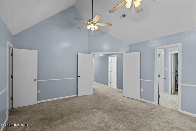 unfurnished bedroom featuring visible vents, baseboards, ceiling fan, carpet flooring, and high vaulted ceiling