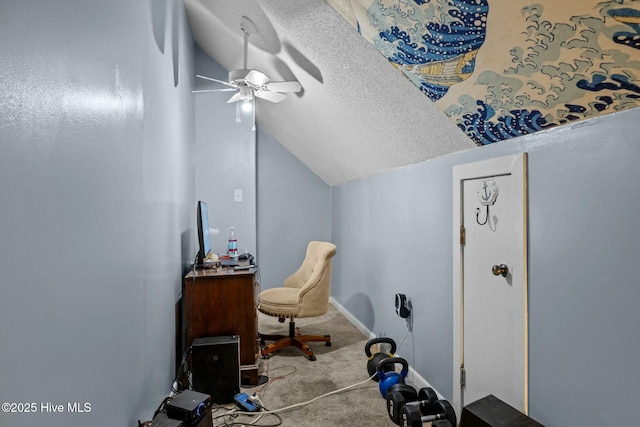 carpeted home office featuring baseboards, a textured ceiling, lofted ceiling, and ceiling fan