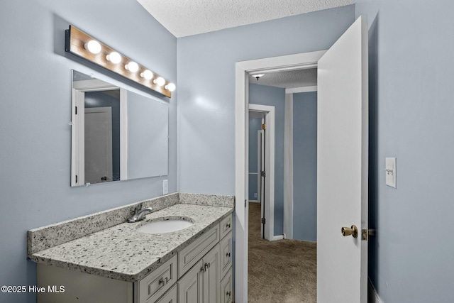 bathroom with a textured ceiling and vanity