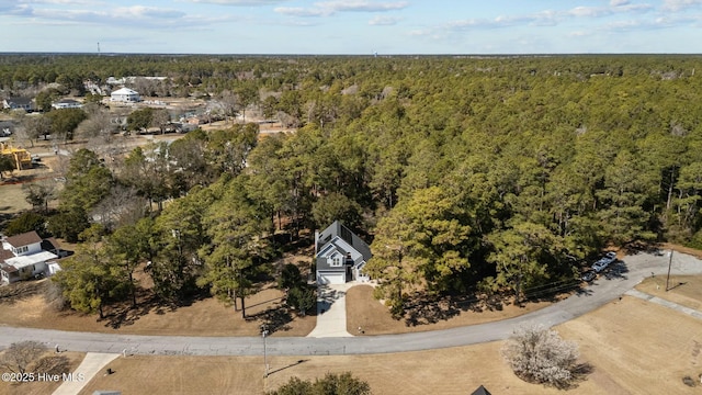 birds eye view of property featuring a wooded view