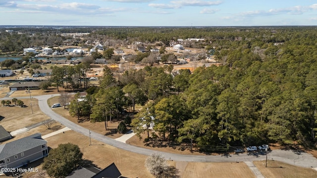 drone / aerial view featuring a forest view