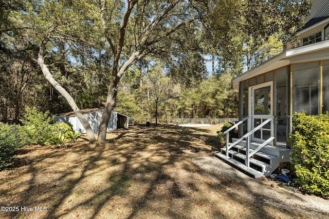 view of yard featuring a sunroom and fence