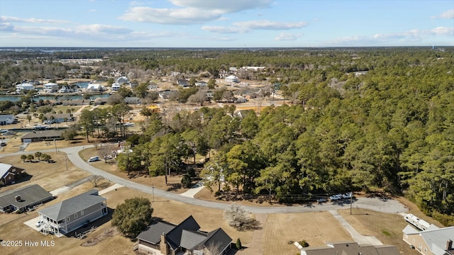 drone / aerial view featuring a wooded view