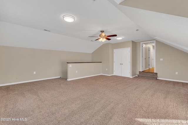 additional living space with visible vents, baseboards, carpet, and ceiling fan