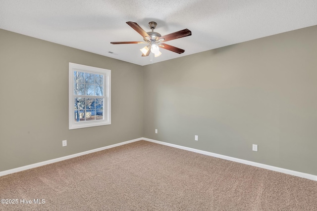 carpeted empty room featuring visible vents, baseboards, a textured ceiling, and ceiling fan