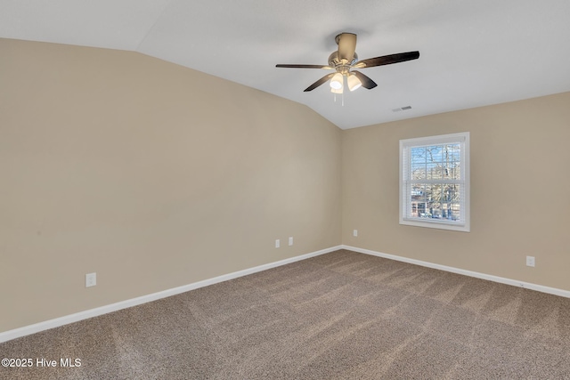 spare room with carpet, a ceiling fan, baseboards, visible vents, and lofted ceiling