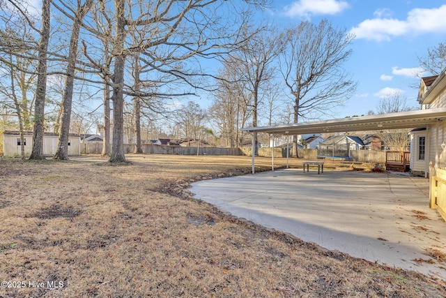 view of yard featuring a trampoline and fence