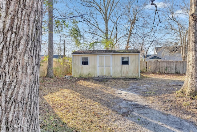 view of shed featuring fence