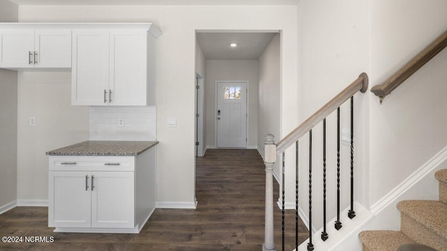 entrance foyer with stairs, baseboards, and dark wood-style flooring