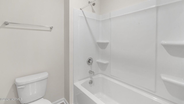 full bathroom with toilet, tub / shower combination, and baseboards