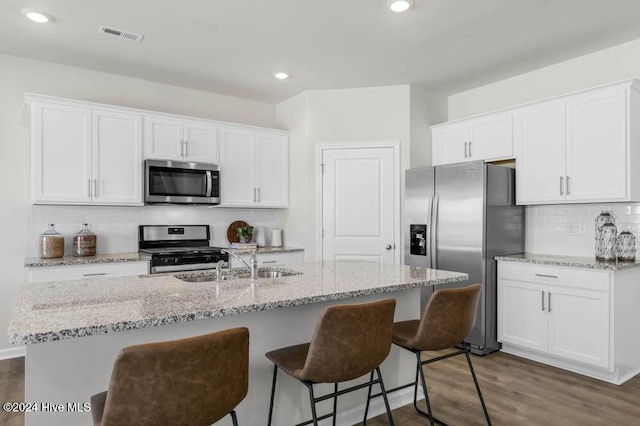 kitchen with appliances with stainless steel finishes and white cabinets