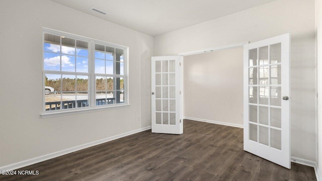 spare room featuring french doors, baseboards, dark wood-type flooring, and visible vents