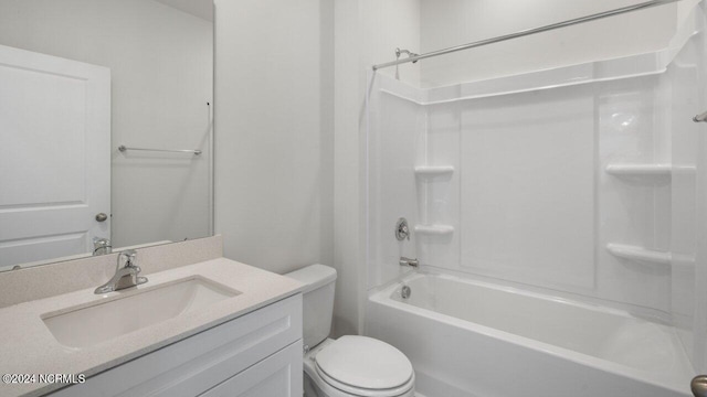 bathroom featuring toilet, vanity, and  shower combination