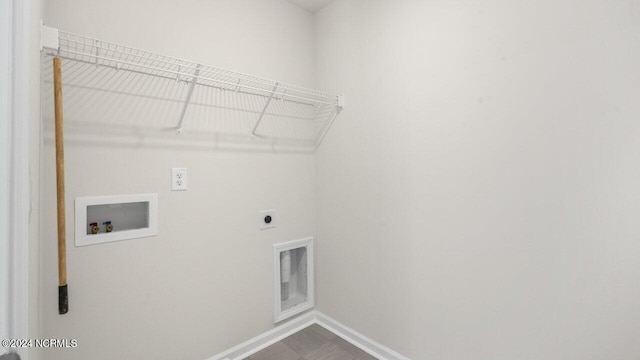 clothes washing area featuring washer hookup, laundry area, baseboards, and hookup for an electric dryer