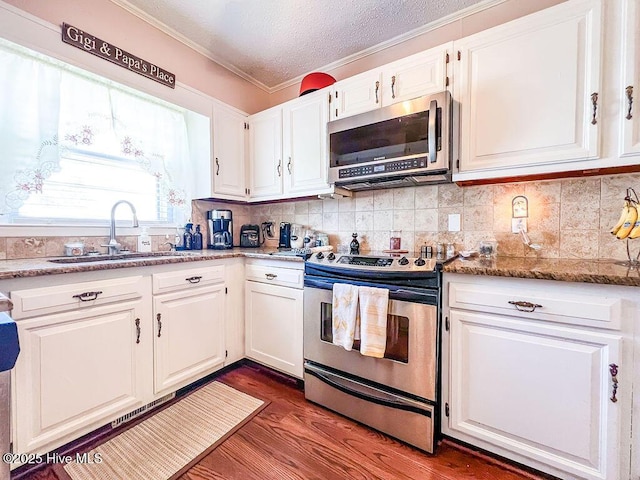 kitchen featuring white cabinetry, stainless steel appliances, and a sink