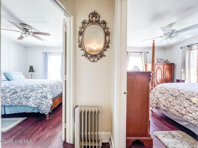 bedroom with a ceiling fan, radiator heating unit, wood finished floors, and ornamental molding