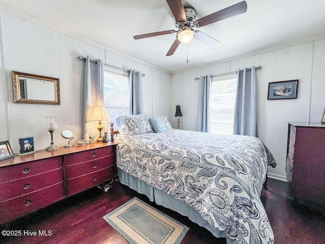 bedroom with dark wood-style floors, multiple windows, crown molding, and ceiling fan