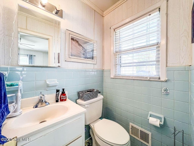 bathroom featuring visible vents, toilet, ornamental molding, and vanity