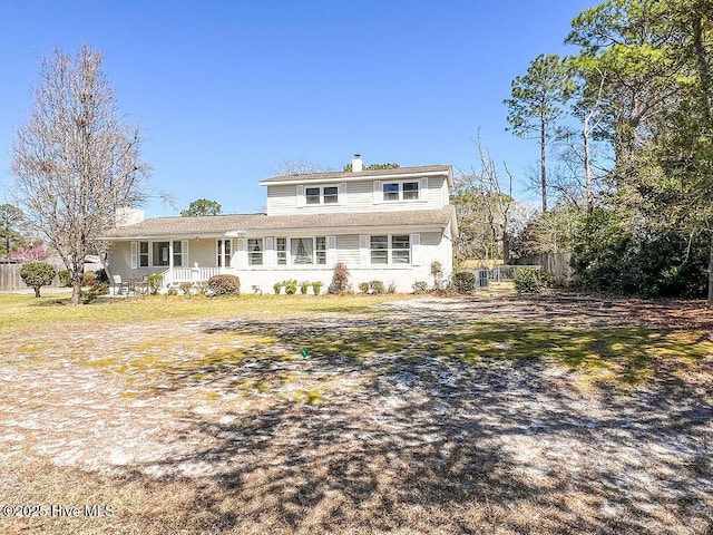 back of property featuring a chimney and fence