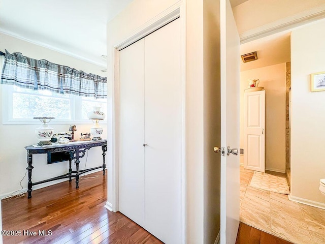 hallway with hardwood / wood-style floors