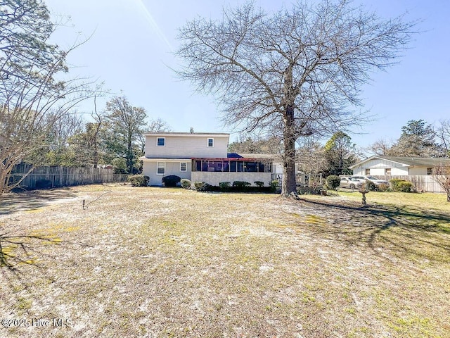 rear view of house with fence