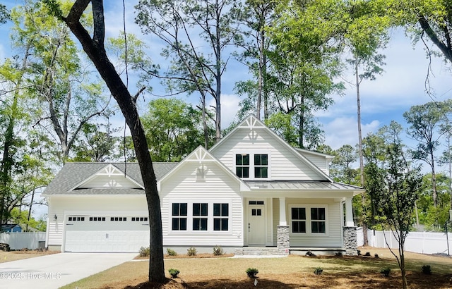 9018 Ocean Harbour Golf Club Rd SW Unit 5, Calabash, NC 28467 - view of front facade featuring an attached garage, a standing seam roof, driveway, metal roof, and roof with shingles