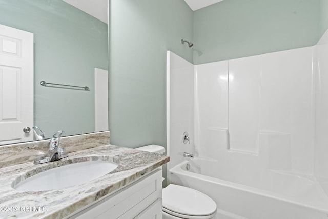 full bath with toilet, vanity, and  shower combination