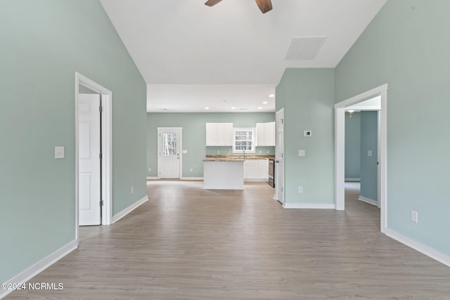 unfurnished living room with visible vents, baseboards, recessed lighting, light wood-style flooring, and a ceiling fan