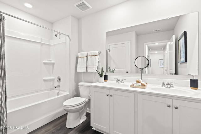 bathroom with toilet, visible vents, and a sink