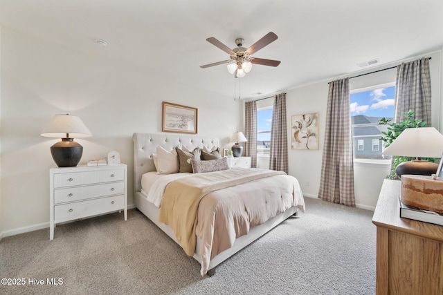 bedroom featuring visible vents, light carpet, baseboards, and a ceiling fan