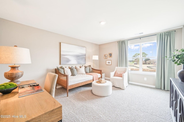 living area featuring visible vents, carpet floors, and baseboards