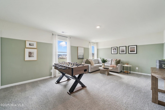 recreation room featuring visible vents, baseboards, and light carpet