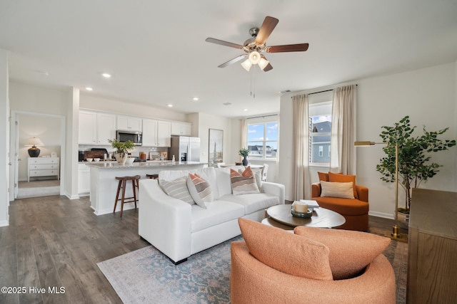 living area featuring dark wood finished floors, recessed lighting, baseboards, and ceiling fan