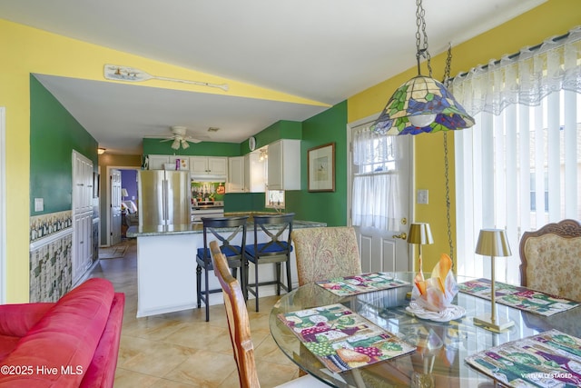 179 Sea Gull Ln, North Topsail Beach, NC 28460 - dining area with ceiling fan, light tile patterned floors, and vaulted ceiling