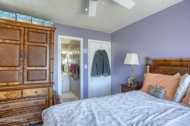 179 Sea Gull Ln, North Topsail Beach, NC 28460 - bedroom with ensuite bathroom, a textured ceiling, a ceiling fan, and carpet
