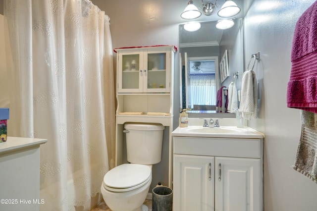 179 Sea Gull Ln, North Topsail Beach, NC 28460 - bathroom with toilet, vanity, and ornamental molding