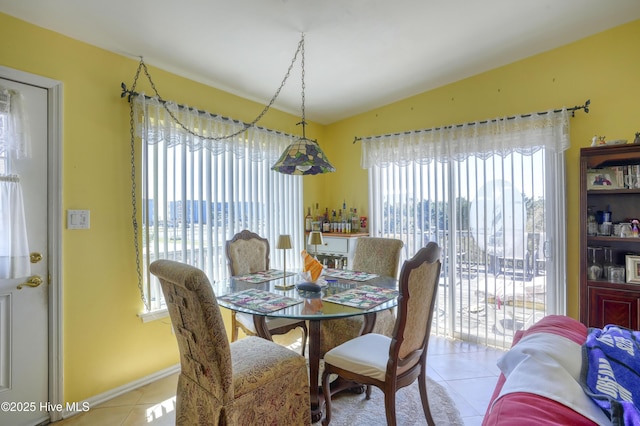 179 Sea Gull Ln, North Topsail Beach, NC 28460 - dining area featuring light tile patterned flooring, vaulted ceiling, and baseboards